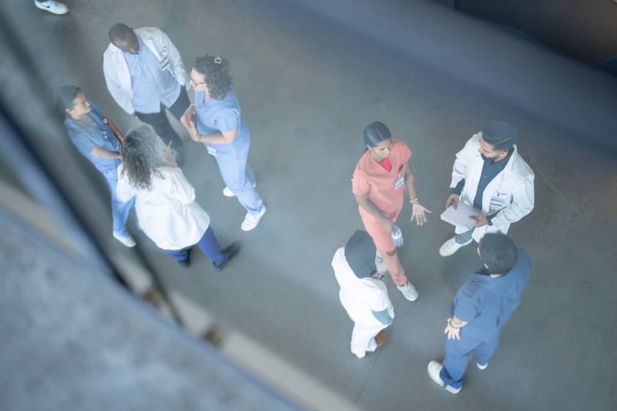 Healthcare professionals consulting in a hospital corridor